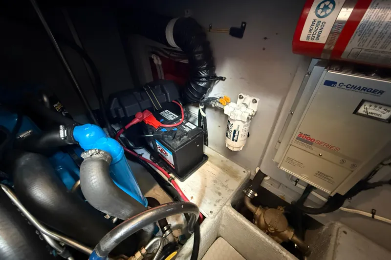 Slide: The Image of Engine room of a 1999 Silverton 322 Motor Yacht with battery and charger. - 24