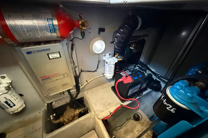 Slide: The Image of Engine room of a 1999 Silverton 322 Motor Yacht with battery and fire extinguisher. - 25
