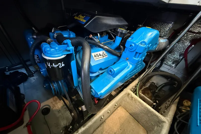 Slide: The Image of Engine compartment of a 1999 Silverton 322 Motor Yacht, featuring a blue engine. - 26