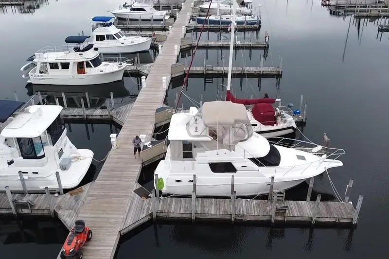 Slide: The Image of 1999 Silverton 322 Motor Yacht docked at marina with other boats. - 5