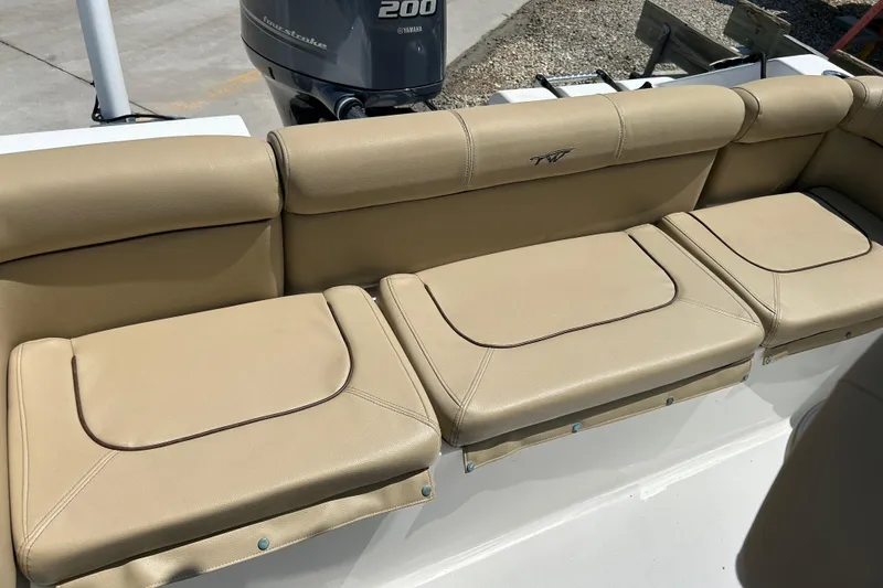 Slide: The Image of 2016 Tidewater 210 LXF boat with beige cushioned seating and Yamaha 200 outboard motor. - 11