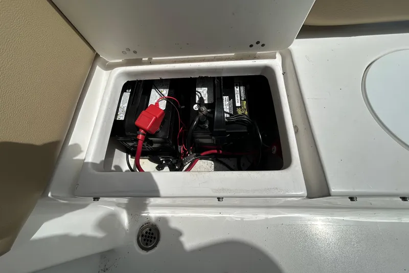 Slide: The Image of Battery compartment of a 2016 Tidewater 210 LXF boat, showing wiring and connections. - 12