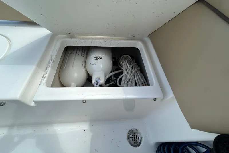 Slide: The Image of Storage compartment on 2016 Tidewater 210 LXF boat with fenders and rope. - 14