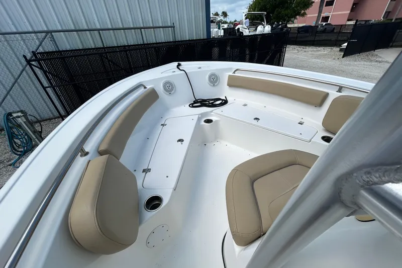 Slide: The Image of 2016 Tidewater 210 LXF boat interior with beige seating and white deck. - 15