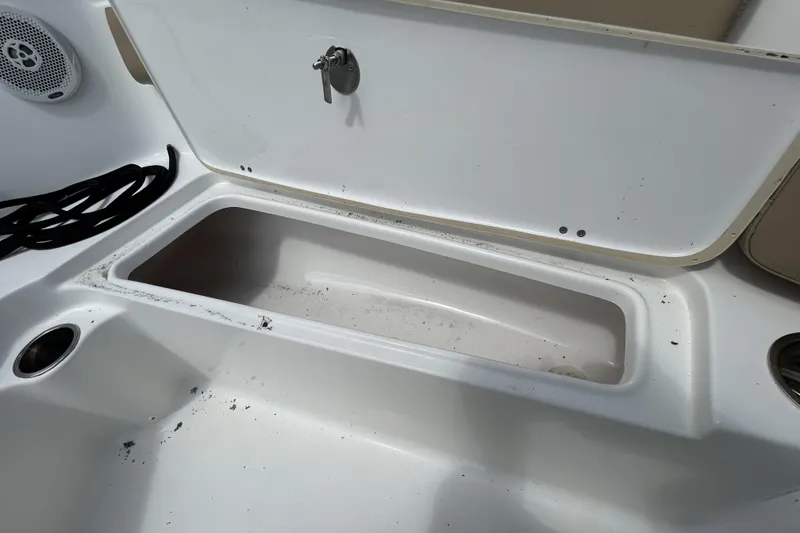Slide: The Image of Open storage compartment on a 2016 Tidewater 210 LXF boat, showing interior details. - 16