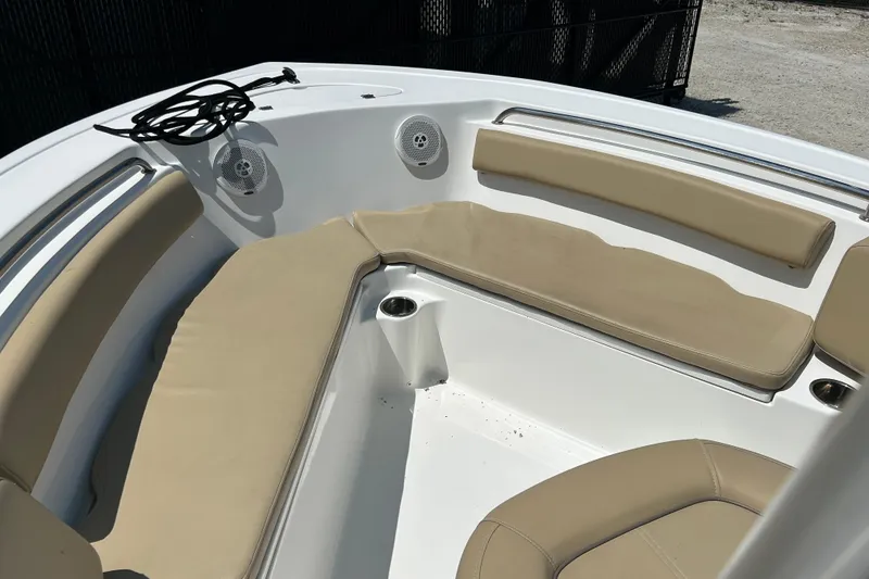 Slide: The Image of 2016 Tidewater 210 LXF boat interior with beige cushioned seating and cup holders. - 17
