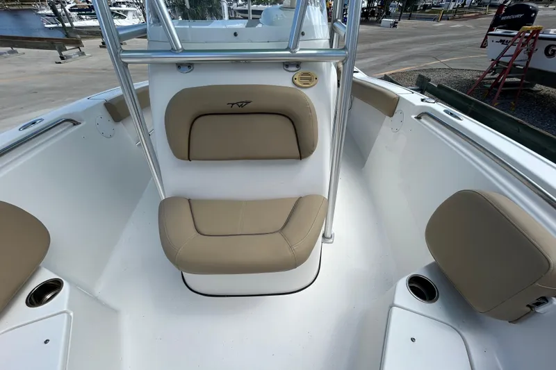 Slide: The Image of 2016 Tidewater 210 LXF boat interior with beige seating and stainless steel railings. - 18