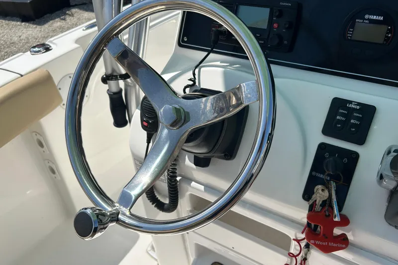 Slide: The Image of Steering wheel and controls of a 2016 Tidewater 210 LXF boat cockpit. - 19