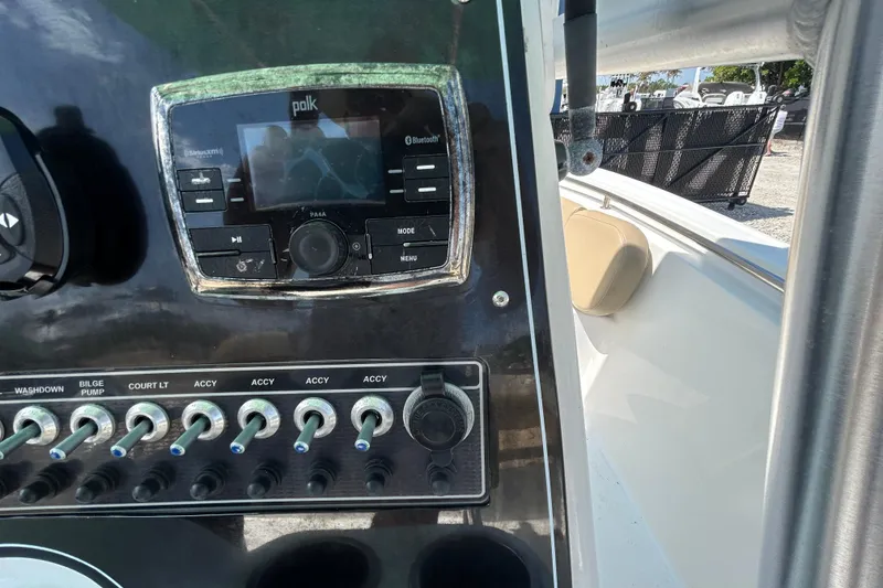 Slide: The Image of Control panel of a 2016 Tidewater 210 LXF boat with audio system and switches. - 23