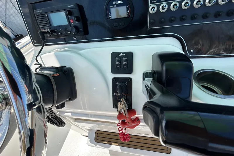 Slide: The Image of Control panel of a 2016 Tidewater 210 LXF boat with steering wheel and electronics. - 24