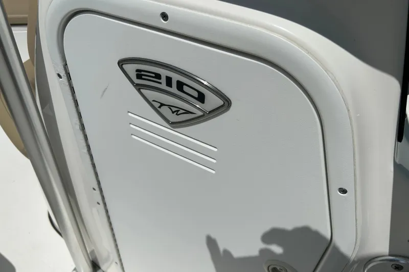 Slide: The Image of Close-up of a 2016 Tidewater 210 LXF boat emblem on a white panel. - 25