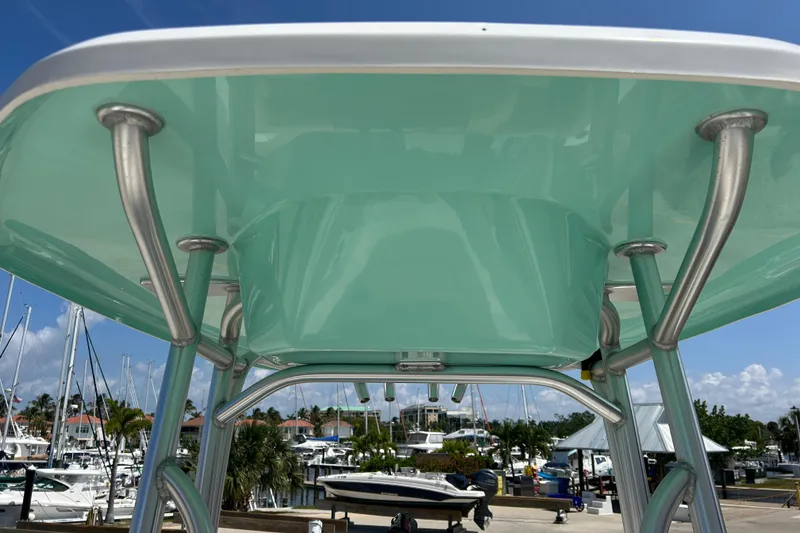 Slide: The Image of Tidewater 210 LXF 2016 boat T-top with marina background on a sunny day. - 28