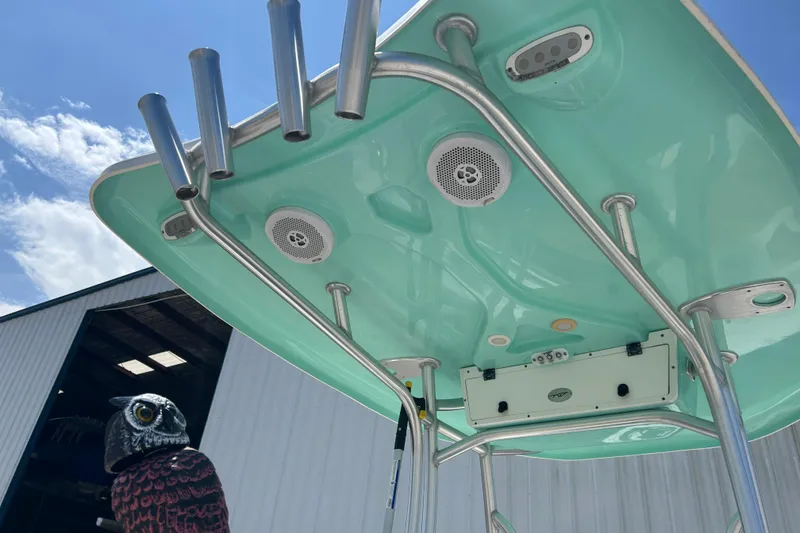 Slide: The Image of Tidewater 210 LXF 2016 boat with speakers and rod holders under a clear sky. - 29