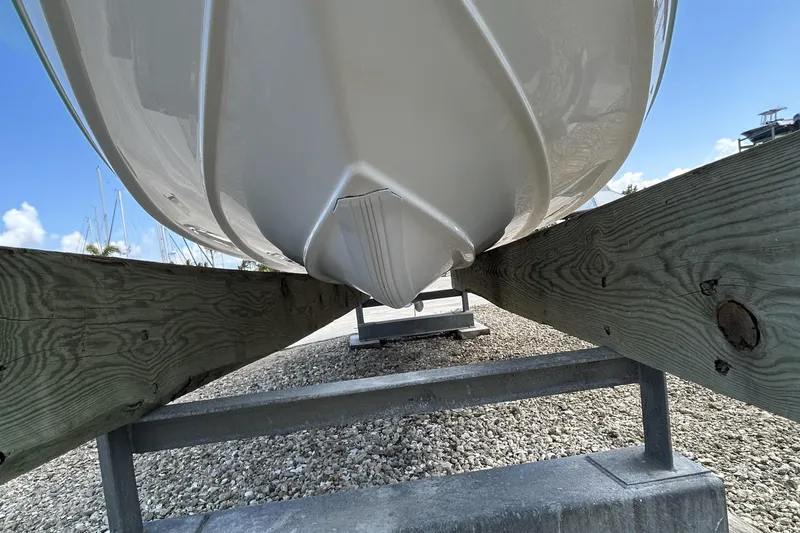 Slide: The Image of 2016 Tidewater 210 LXF boat hull on wooden supports, outdoor setting. - 3