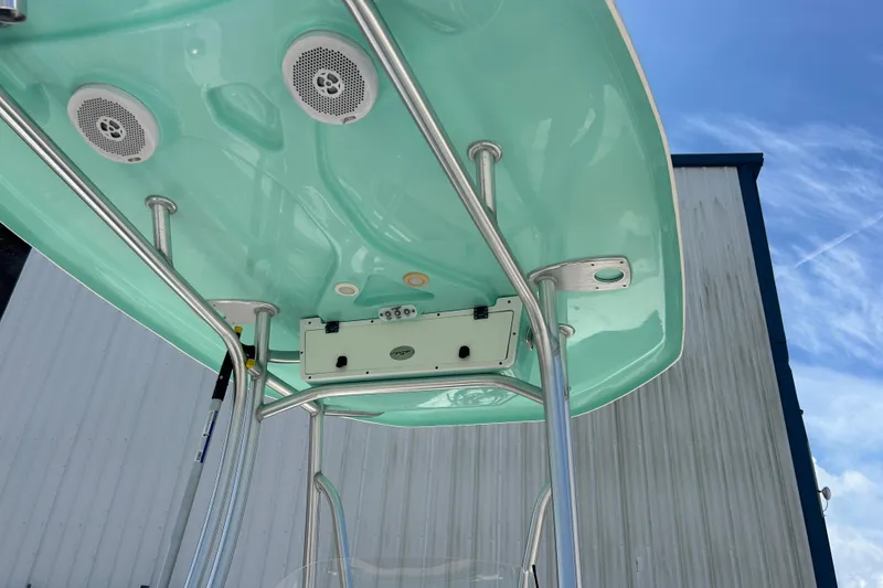 Slide: The Image of 2016 Tidewater 210 LXF boat T-top with speakers and blue sky background. - 30