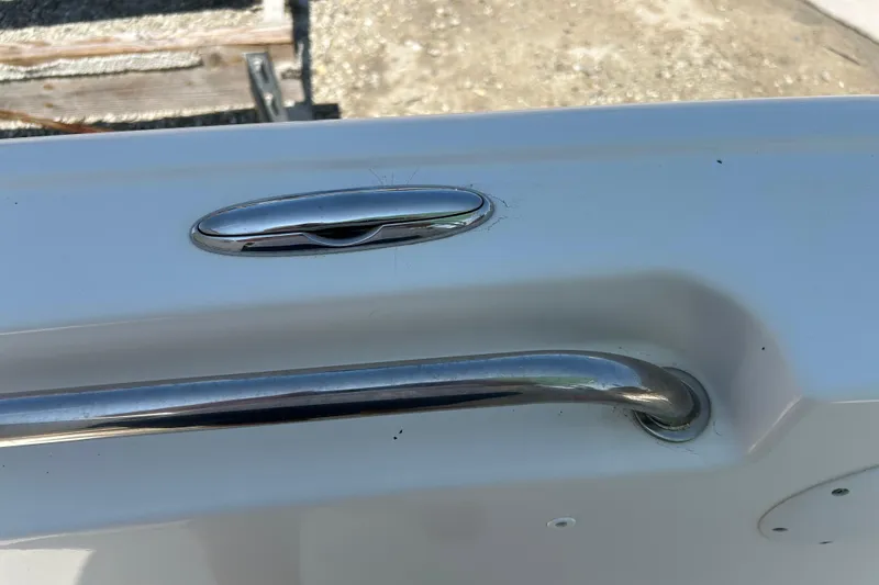 Slide: The Image of Close-up of a 2016 Tidewater 210 LXF boat's stainless steel cleat and handle. - 32
