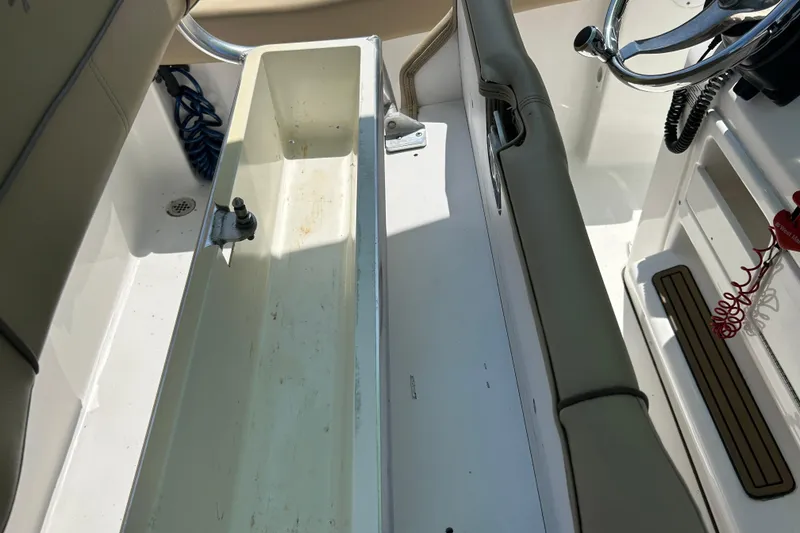 Slide: The Image of Interior view of a 2016 Tidewater 210 LXF boat cockpit with steering wheel and seating. - 9