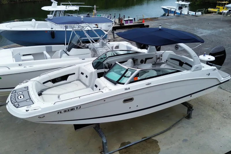 Slide: The Image of 2022 Four Winns HD8 OB boat docked, featuring sleek design and spacious seating. - 10