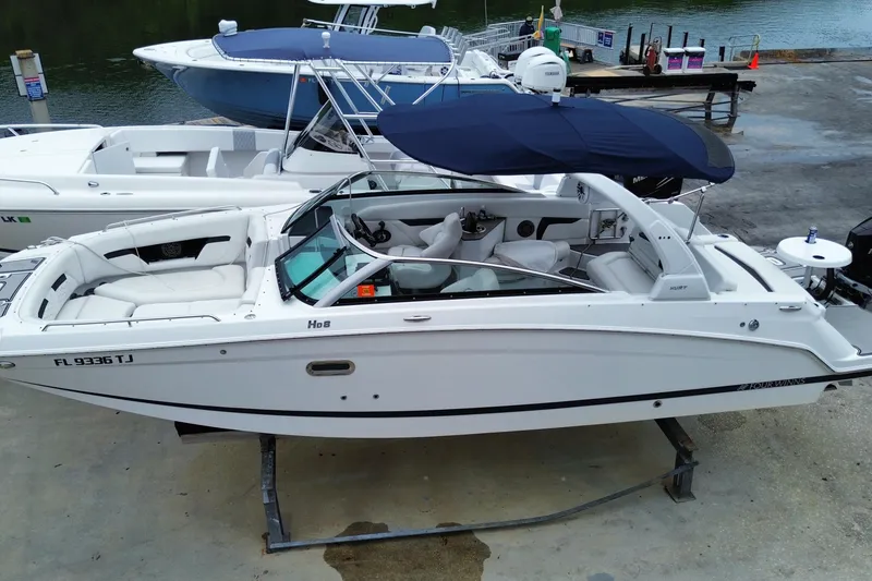 Slide: The Image of 2022 Four Winns HD8 OB boat with canopy, docked at marina. - 11
