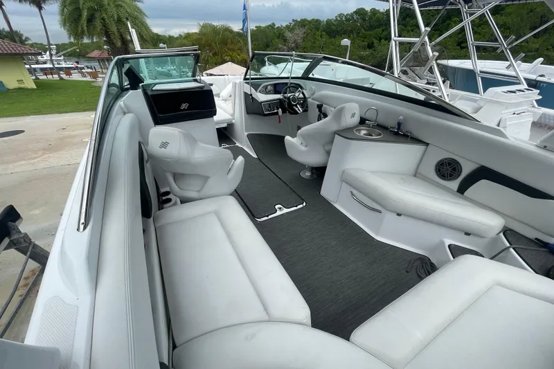 Slide: The Image of 2022 Four Winns HD8 OB boat interior with white seating and modern dashboard. - 16