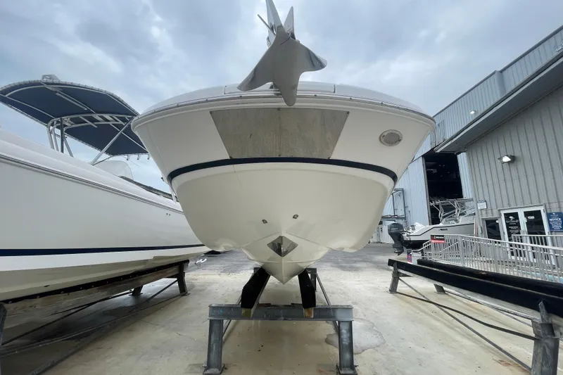 Slide: The Image of 2022 Four Winns HD8 OB boat on display in a marina setting. - 21
