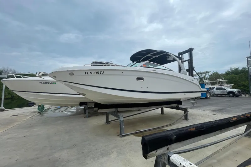 Slide: The Image of 2022 Four Winns HD8 OB boat on a dock, ready for launch. - 23