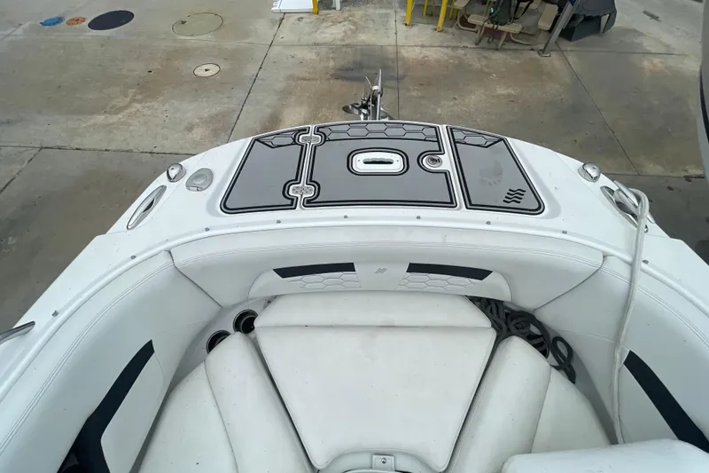 Slide: The Image of 2022 Four Winns HD8 OB boat interior with white seating and deck details. - 25
