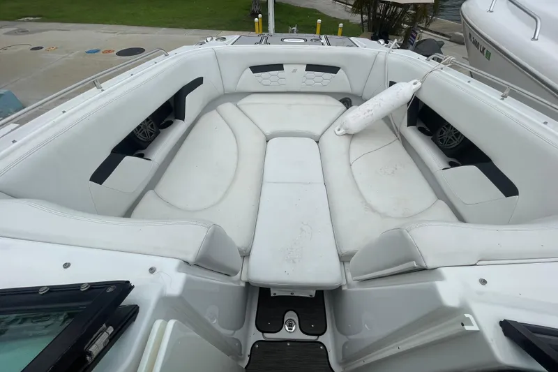 Slide: The Image of 2022 Four Winns HD8 OB boat interior with spacious white seating area. - 26