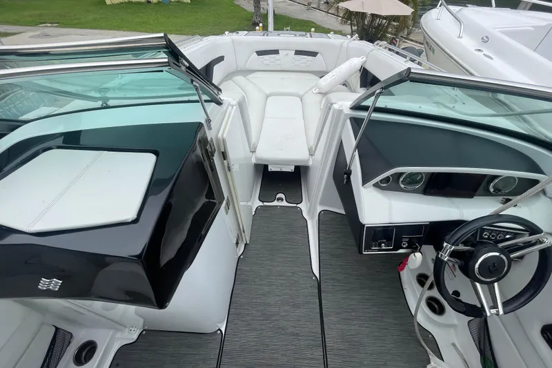Slide: The Image of 2022 Four Winns HD8 OB boat interior with sleek design and modern dashboard. - 27
