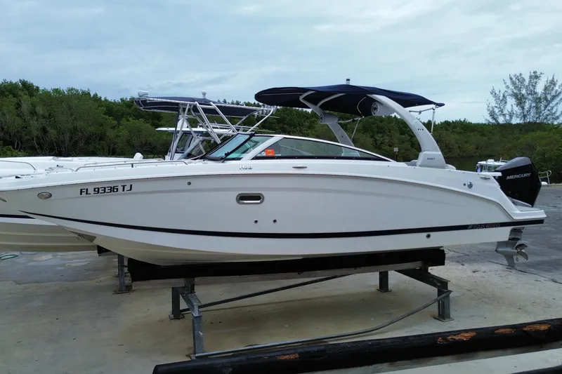 Slide: The Image of 2022 Four Winns HD8 OB boat on display, featuring sleek design and Mercury outboard engine. - 3