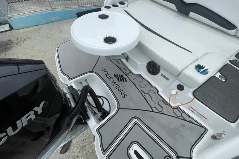 Slide: The Image of 2022 Four Winns HD8 OB boat deck with seating and Mercury engine. - 30