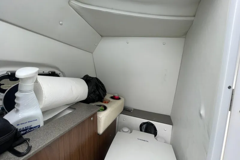 Slide: The Image of Interior of 2022 Four Winns HD8 OB boat with compact restroom amenities. - 39