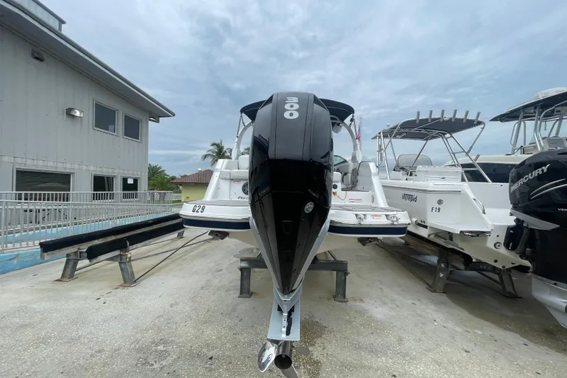 Slide: The Image of 2022 Four Winns HD8 OB boat with 300 horsepower engine, docked outdoors. - 41