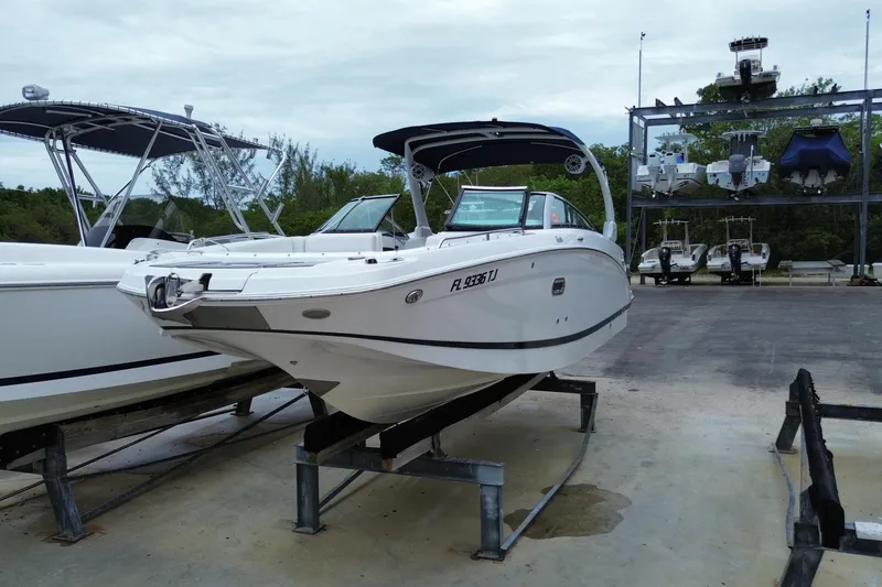 Slide: The Image of 2022 Four Winns HD8 OB boat on a lift at a marina, ready for use. - 5