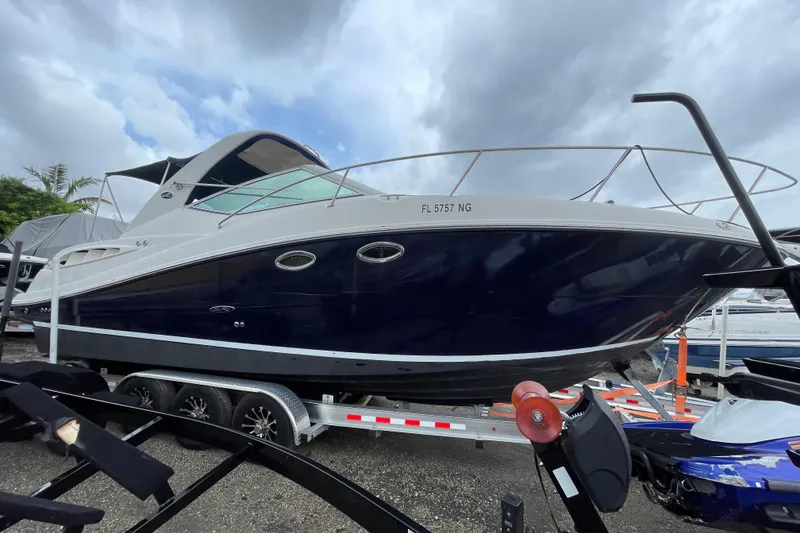 Slide: The Image of 2006 Sea Ray 290 Sundancer boat on trailer under cloudy sky. - 19