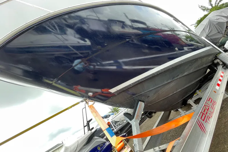 Slide: The Image of 2006 Sea Ray 290 Sundancer boat on trailer, secured with orange straps. - 20