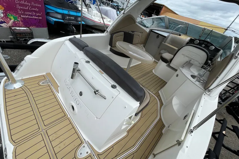 Slide: The Image of 2006 Sea Ray 290 Sundancer boat interior with seating, table, and helm. - 22