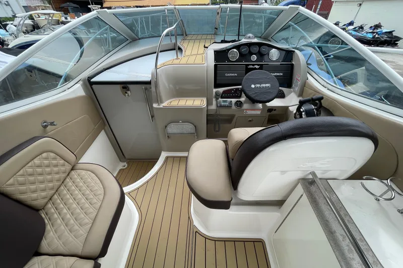 Slide: The Image of 2006 Sea Ray 290 Sundancer cockpit with modern controls and comfortable seating. - 28