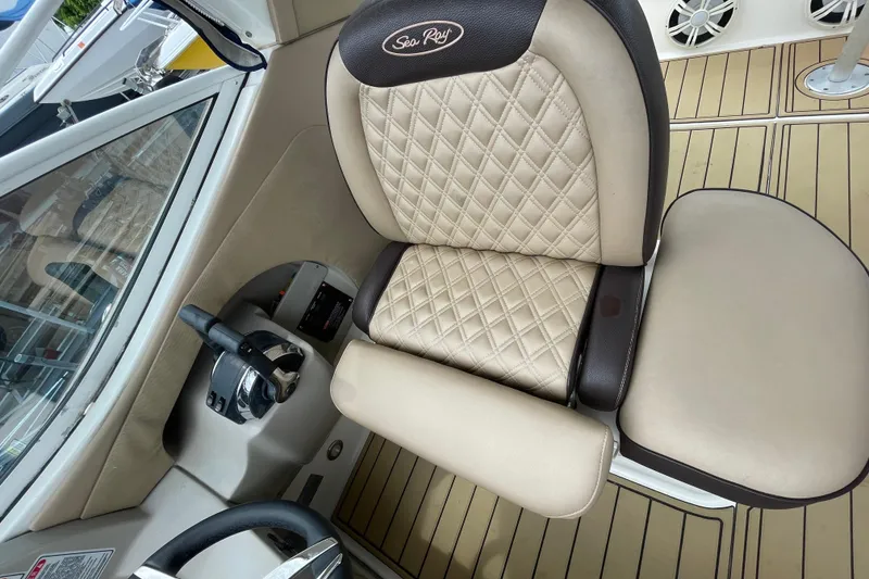 Slide: The Image of Captain's seat of a 2006 Sea Ray 290 Sundancer with quilted upholstery and steering controls. - 30