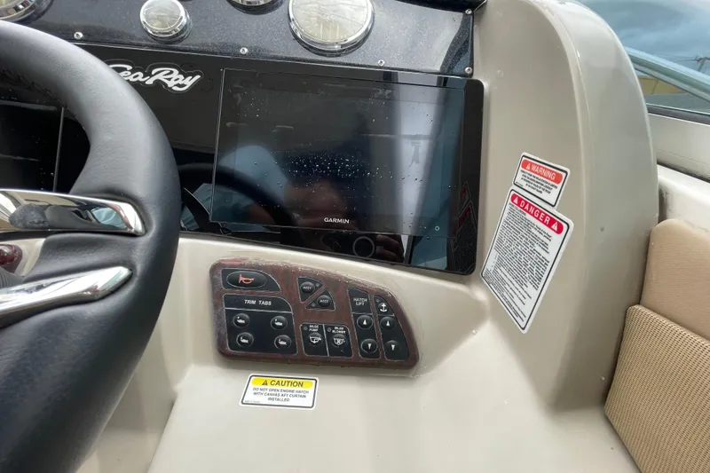 Slide: The Image of Dashboard of a 2006 Sea Ray 290 Sundancer with Garmin display and control panel. - 33