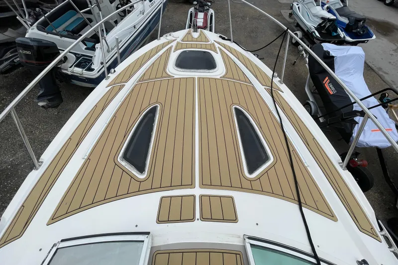 Slide: The Image of 2006 Sea Ray 290 Sundancer boat deck with wood finish and sleek design. - 34