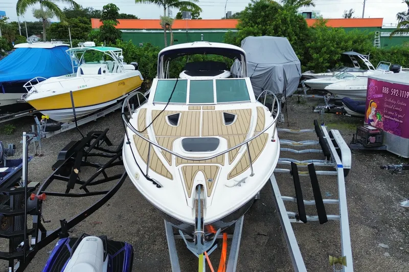 Slide: The Image of 2006 Sea Ray 290 Sundancer boat on trailer in outdoor storage area. - 4