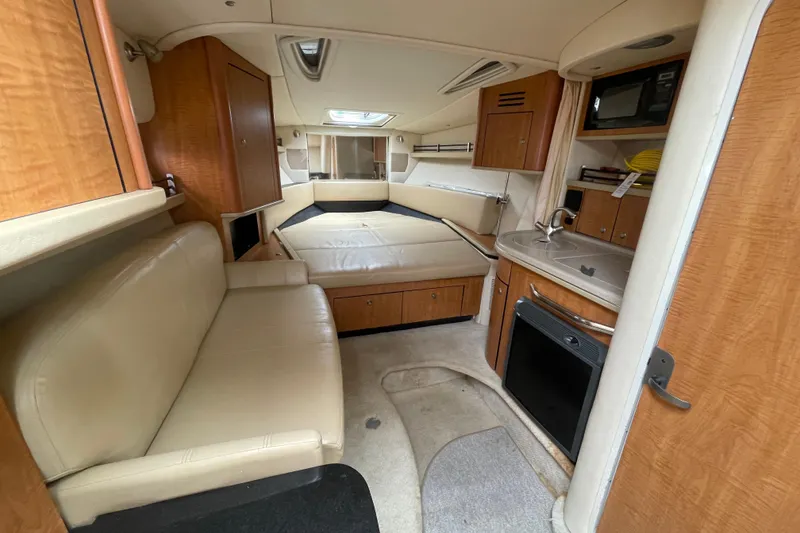Slide: The Image of Interior of 2006 Sea Ray 290 Sundancer boat with kitchenette and seating area. - 40