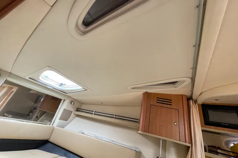 Slide: The Image of Interior cabin of 2006 Sea Ray 290 Sundancer with skylight and wooden cabinetry. - 45