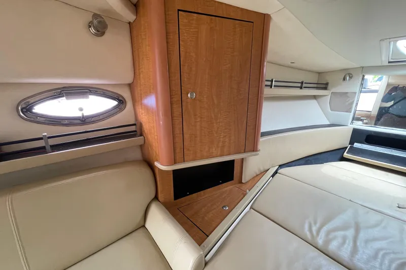 Slide: The Image of Interior of 2006 Sea Ray 290 Sundancer boat with wood cabinetry and leather seating. - 47