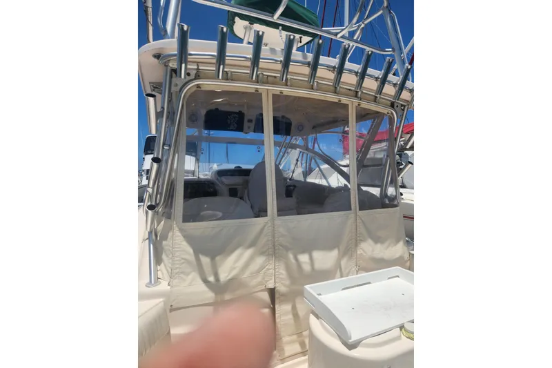 Slide: The Image of 2009 Grady-White Express 330 boat with enclosed cockpit and fishing rod holders. - 11