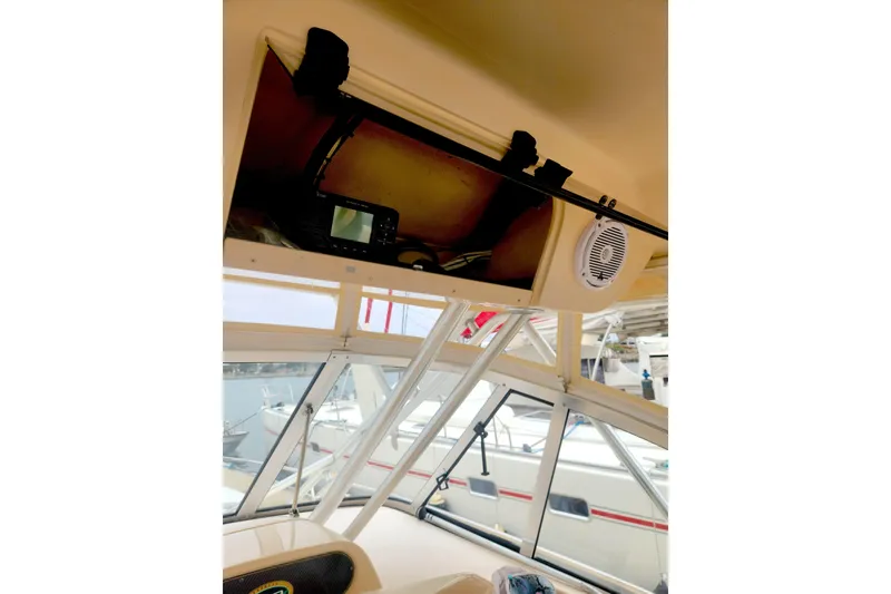 Slide: The Image of 2009 Grady-White Express 330 boat interior with electronics and speaker in storage compartment. - 12