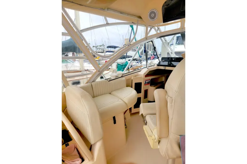 Slide: The Image of 2009 Grady-White Express 330 boat interior with beige seating and helm station. - 13