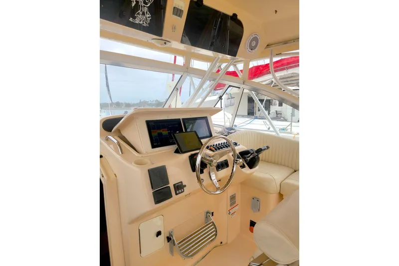 Slide: The Image of 2009 Grady-White Express 330 helm with modern navigation equipment and comfortable seating. - 14