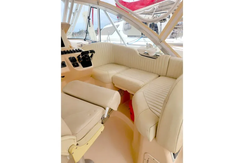 Slide: The Image of 2009 Grady-White Express 330 boat interior with beige seating and control panel. - 15